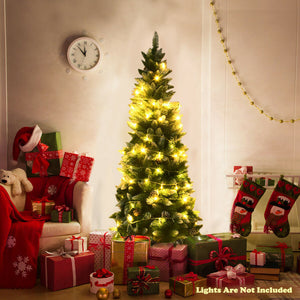 Decorated Christmas tree with lights, presents, and stockings in a living room.