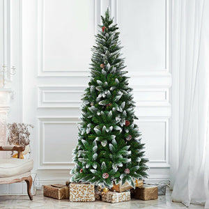 Decorated Christmas tree with presents underneath in a room with white walls and a chair.