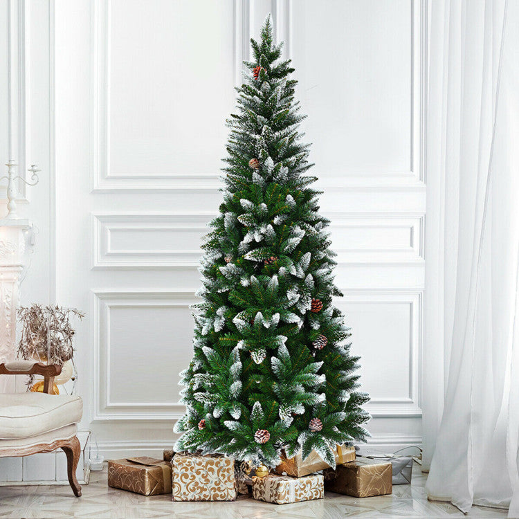Decorated Christmas tree with presents underneath in a room with white walls and a chair.