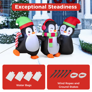 Cute Christmas penguin family inflatable featuring penguins with hat, scarf, and candy cane