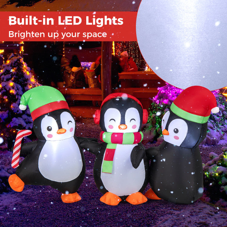 Inflatable penguin family with water bags, ropes, and stakes for secure outdoor setup