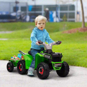 Child playing with a green toy truck on a sidewalk