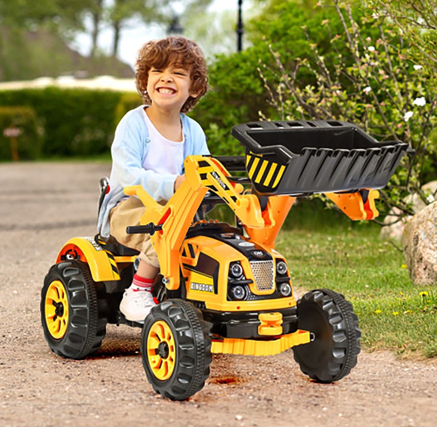 Child playing with a toy construction vehicle outdoors