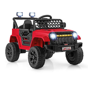 A red and black ride-on toy jeep with off-road tires, a front grille, headlights, roof rack, and light bar, shown on a clean white background.