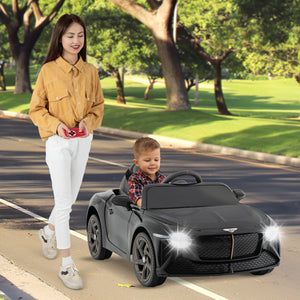 Woman and child with a toy car on a sidewalk in a park