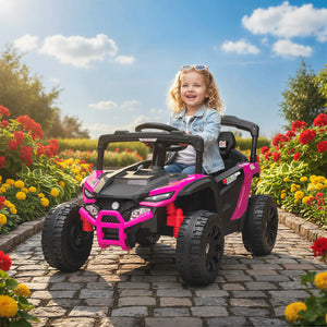Child in a pink and black toy car on a paved path with flowers and trees in the background