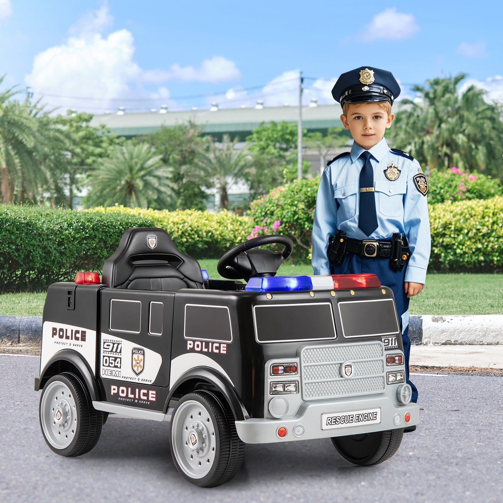 Child in police uniform standing next to a toy police car outdoors.
