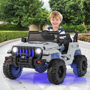 Child sitting in a toy jeep with blue lights in an outdoor setting