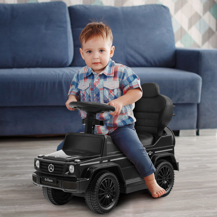 Child playing with a toy Mercedes-Benz car in a living room.