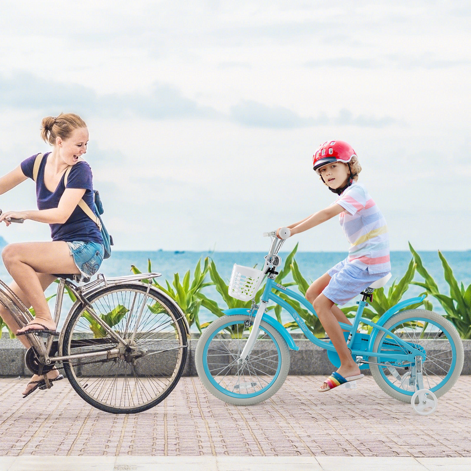Woman and child riding bicycles by a coastal path with greenery and ocean view.