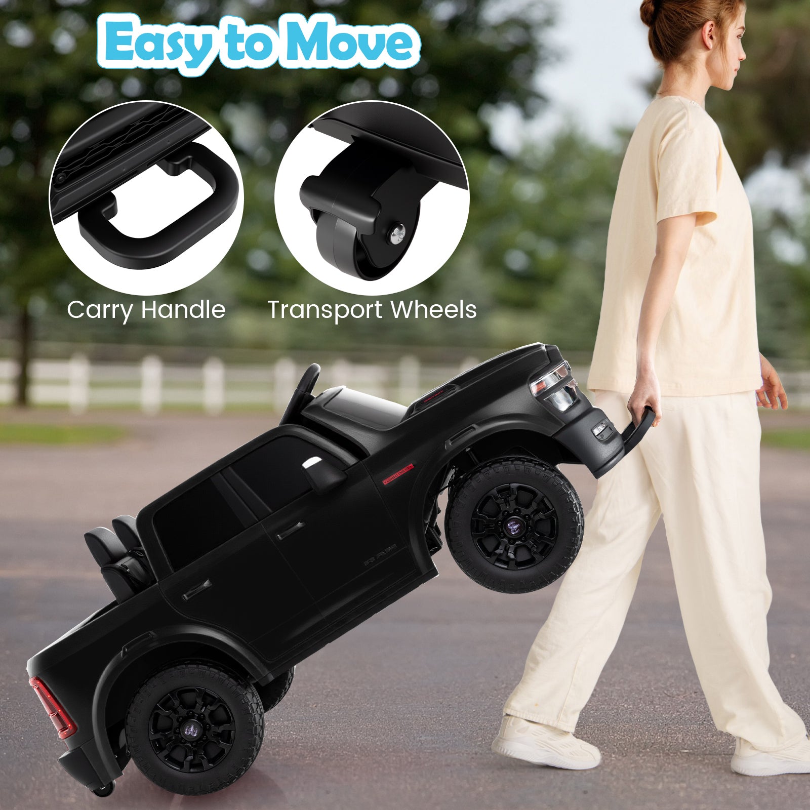 Black toy truck with carry handle and transport wheels, being pushed by a person outdoors.