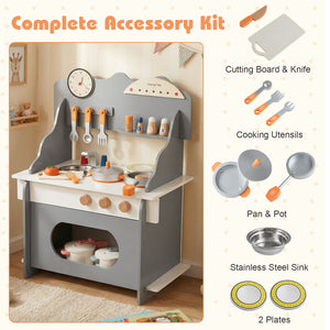 Children's play kitchen set with accessories including a cutting board, knife, cooking utensils, pans, pot, sink, and plates.