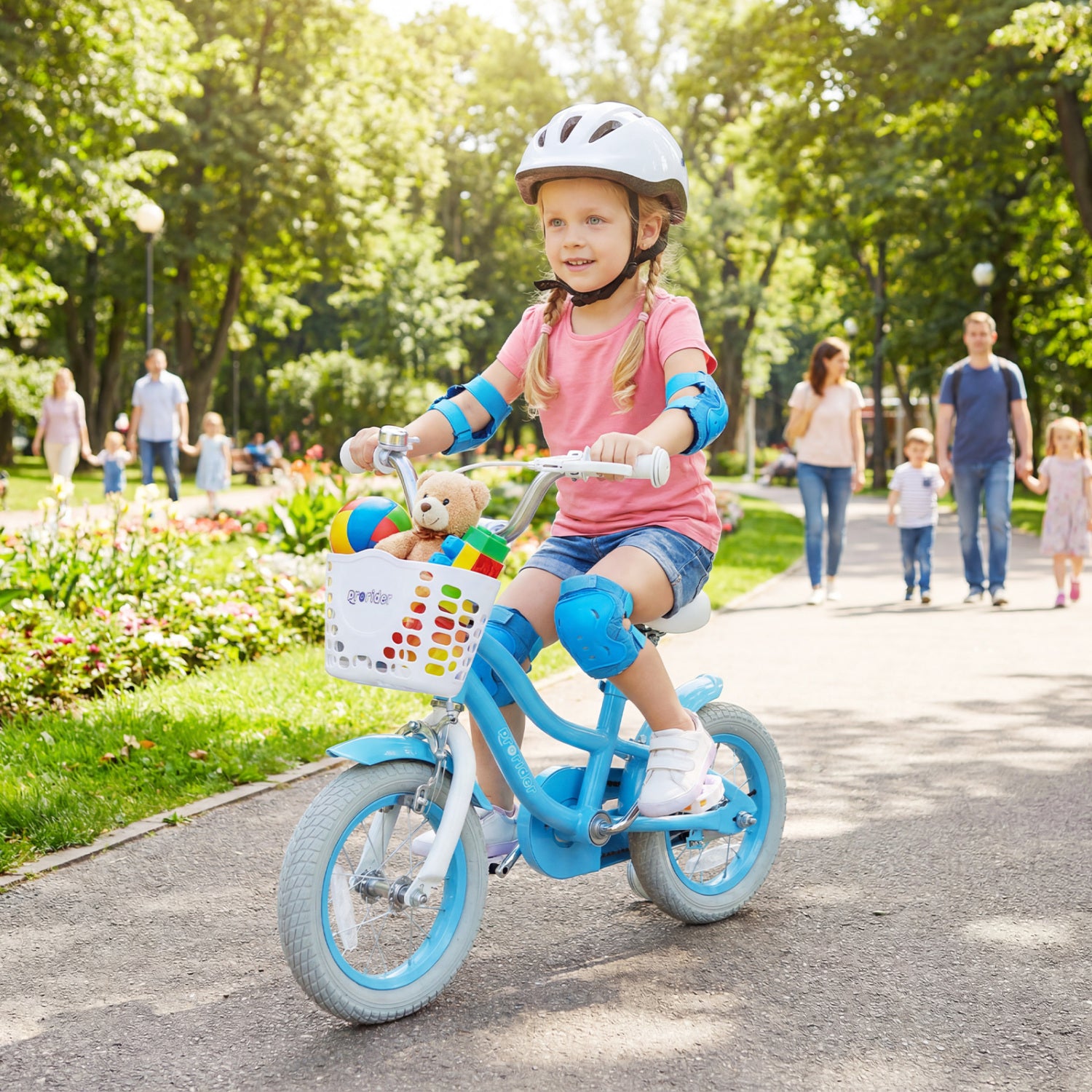 Child riding a bicycle with a helmet and safety pads in a park setting.