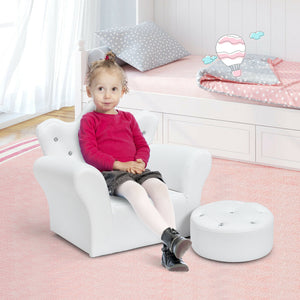Child sitting on a white chair in a bedroom with pink carpet and white walls.