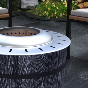 Outdoor fire pit with chairs and garden in the background