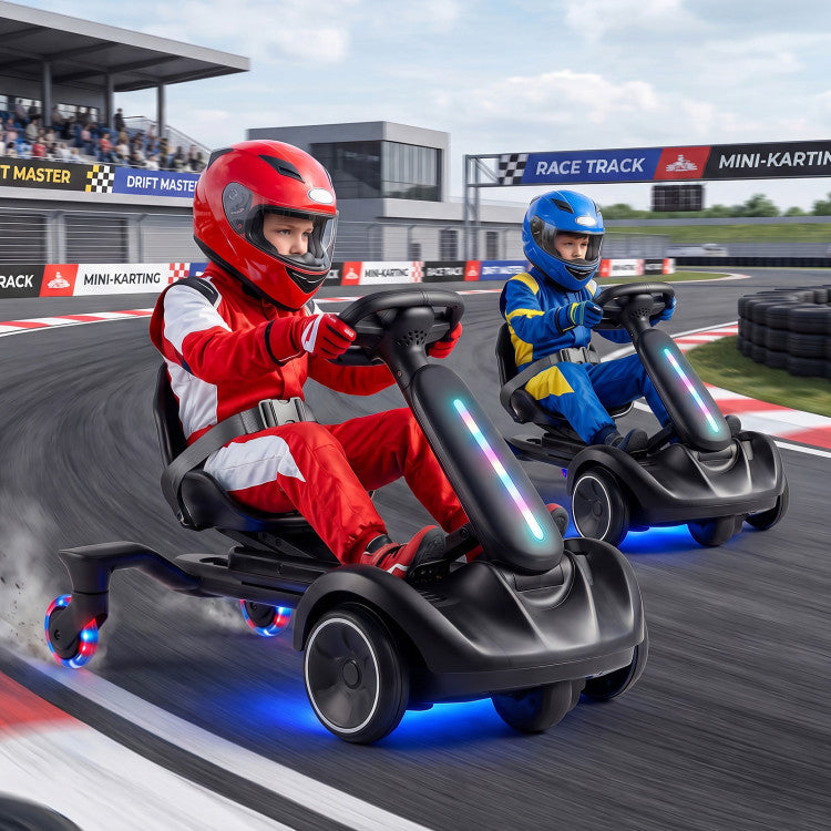 Two children in racing gear driving toy go-karts on a race track.