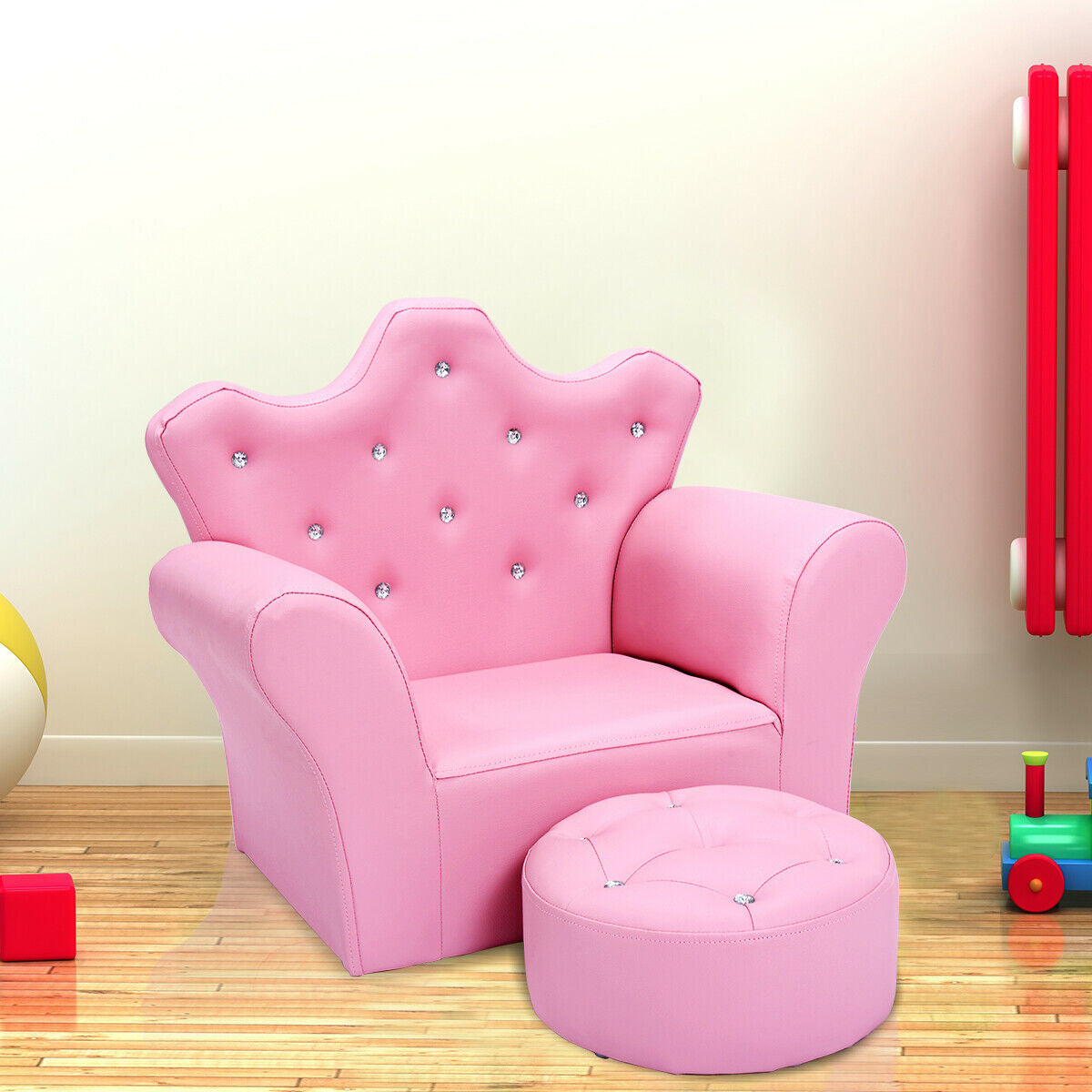 Pink children's chair with a matching ottoman on a wooden floor.