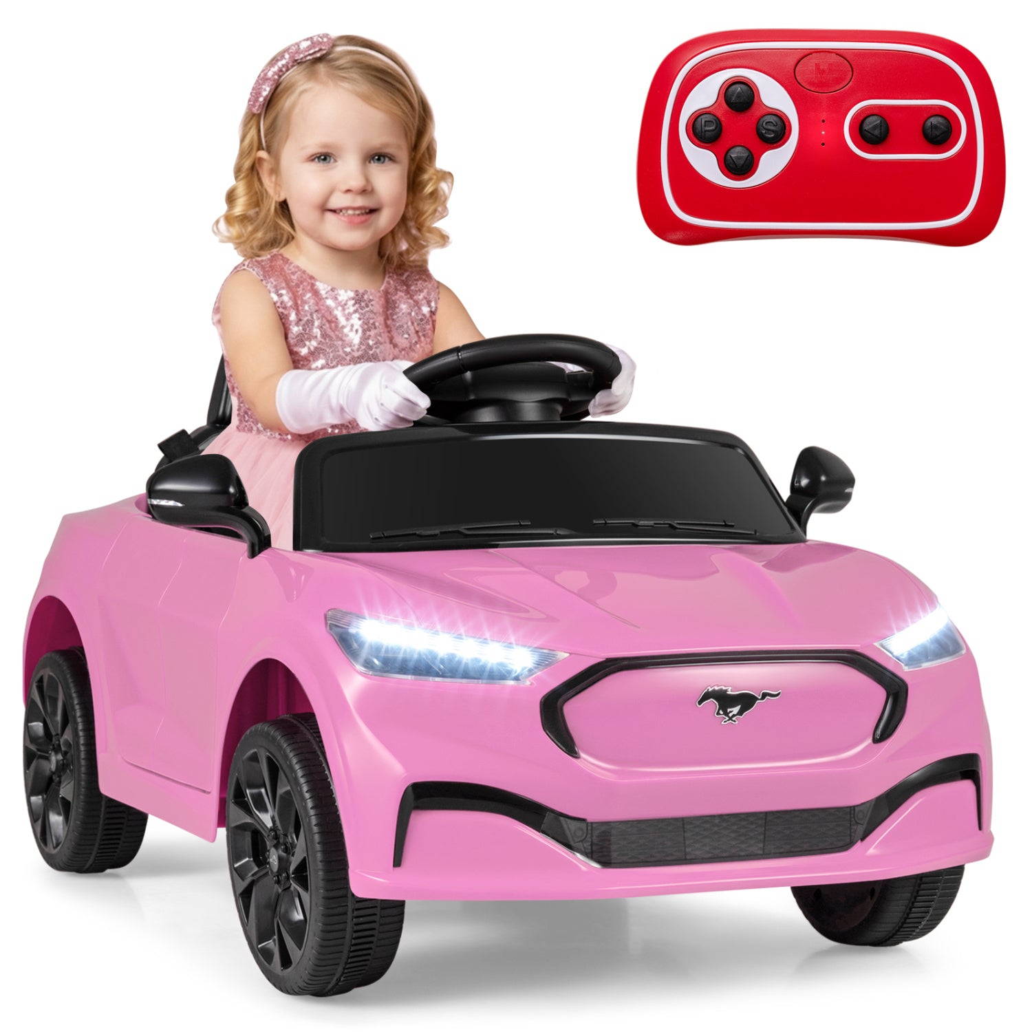 Child in a pink toy car with a remote control on a white background