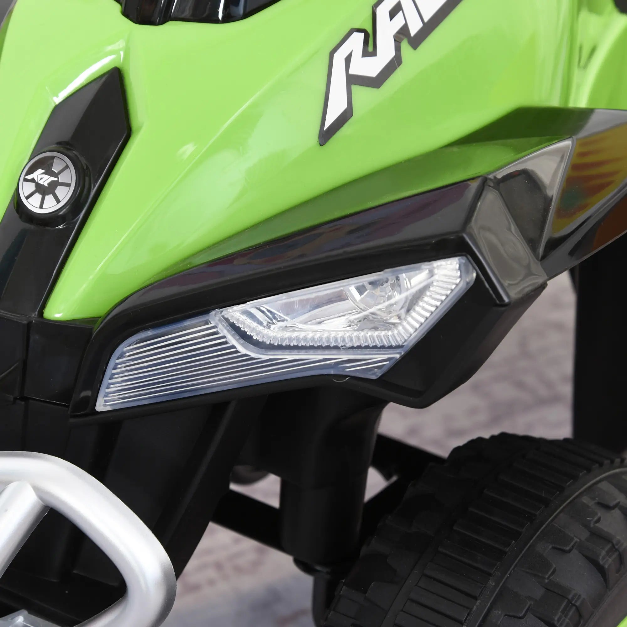 Close-up of a green and black toy motorcycle with 'Rally' branding.
