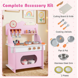 Children's play kitchen set with pink stove and accessories including cutting board, knife, cooking utensils, pans, pot, sink, and plates.