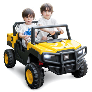 Two children sitting in a yellow and black toy vehicle with a visible brand logo on a white background.
