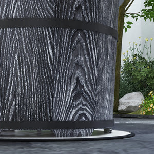 Decorative urn with wooden texture and black band, set against a natural background with plants and rocks.