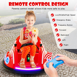 Child sitting in a red toy car with a remote control, outdoors.