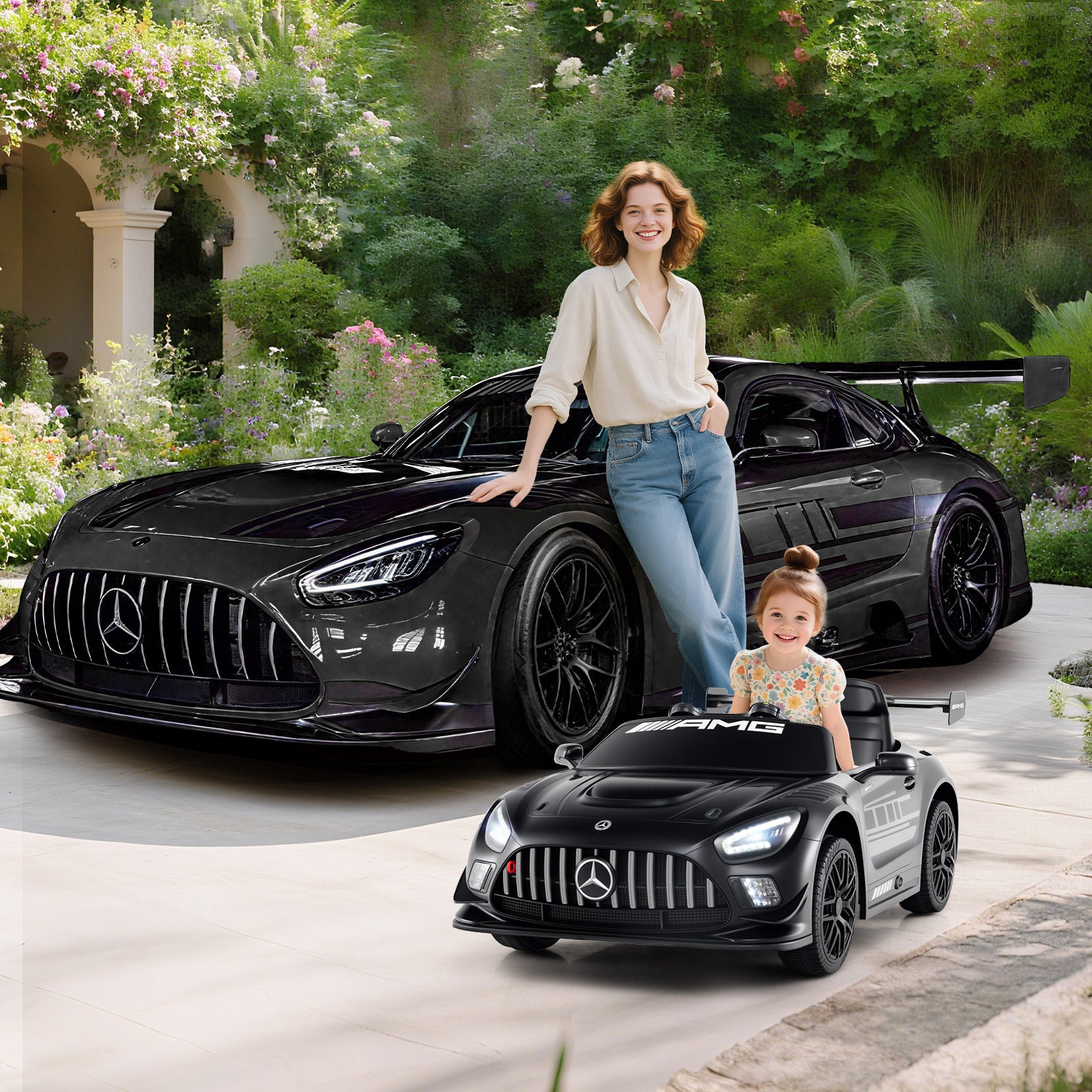 Woman and child with a black Mercedes-Benz car and a smaller model car in a garden setting
