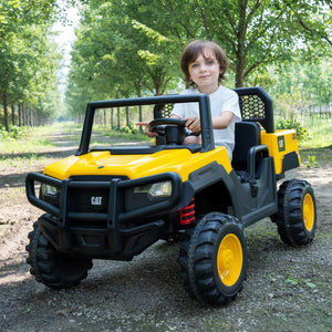 Child sitting in a yellow and black toy vehicle outdoors