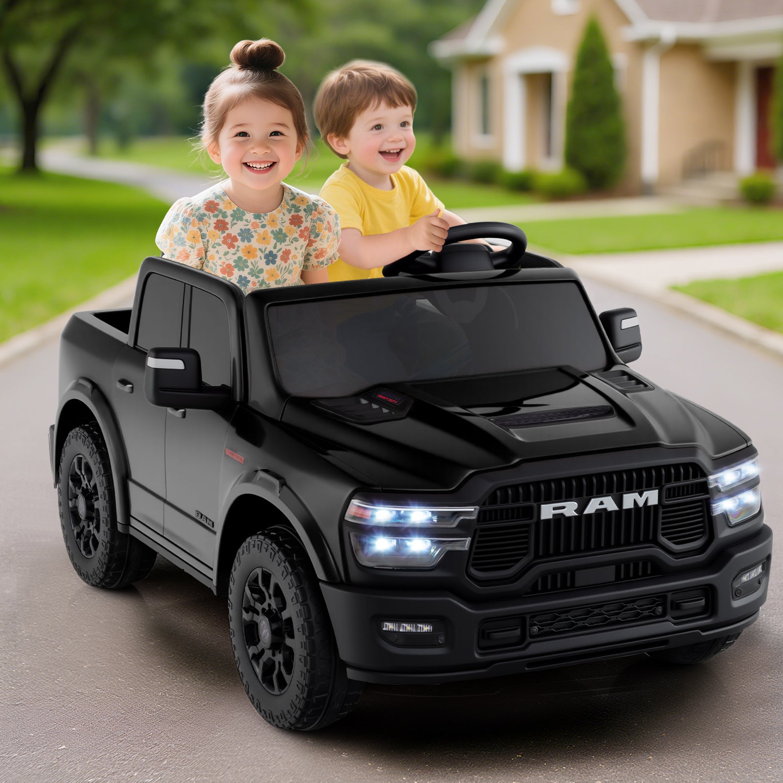 Two children playing in a toy RAM truck on a driveway.