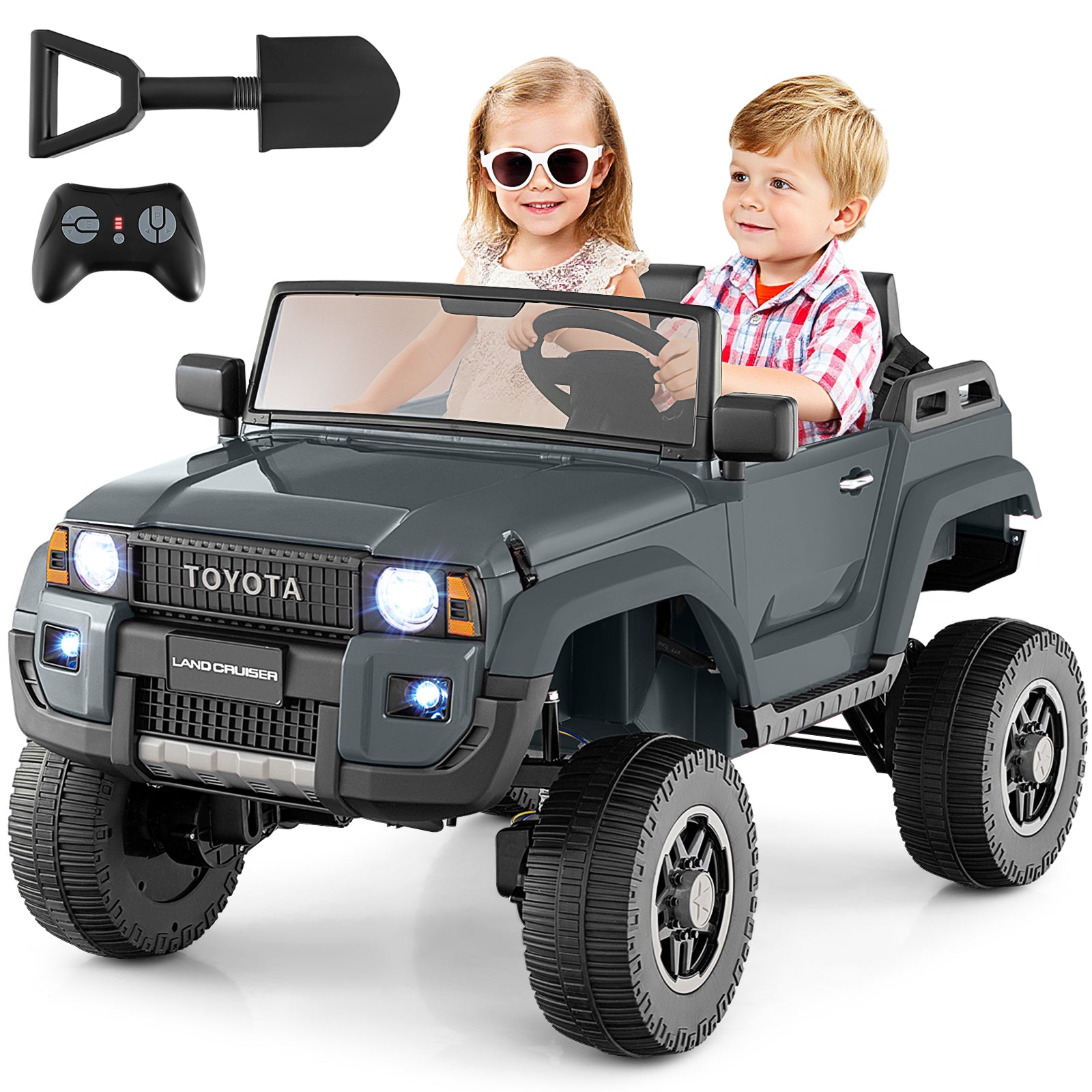 Toy truck with children inside, remote control, and shovel on a white background