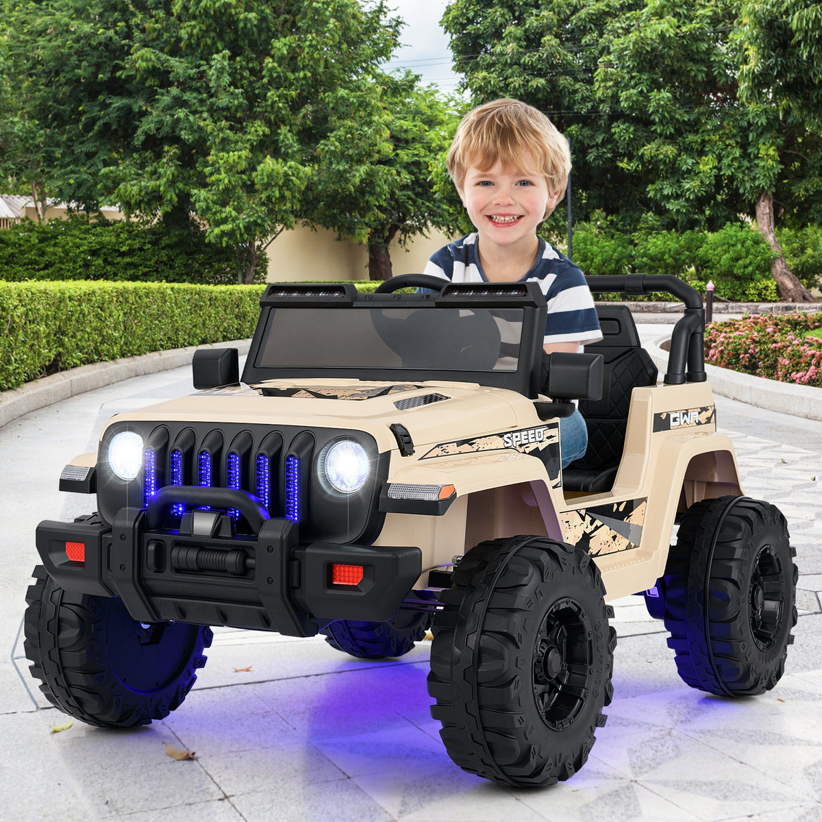Child sitting in a toy jeep with a smiling expression outdoors.