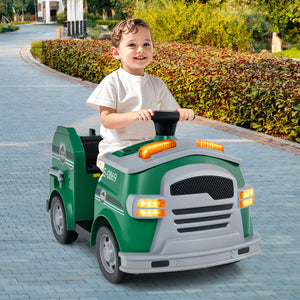Child playing with a green toy truck on a paved road.