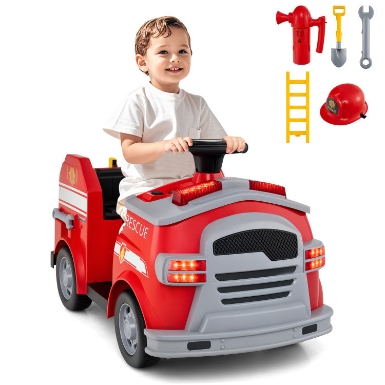 Child playing with a toy fire truck and accessories on a white background