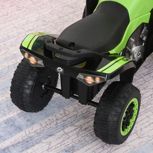 Green and black toy ATV on a textured surface