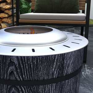 Outdoor fire pit with wooden logs and a bench in the background