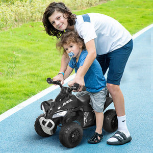 Two children playing with a toy ATV on a blue path.