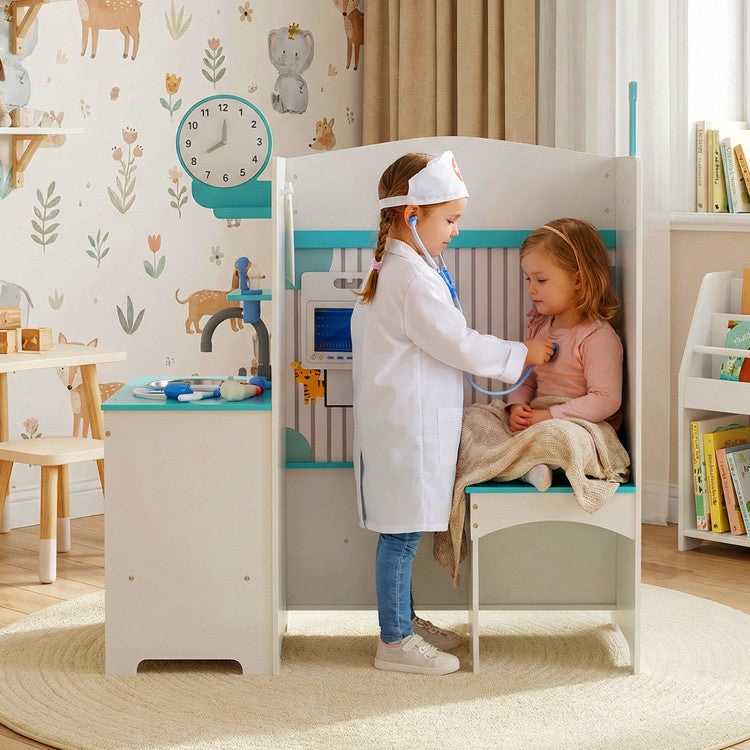 Two children playing a doctor and patient game in a playroom with toys and furniture.
