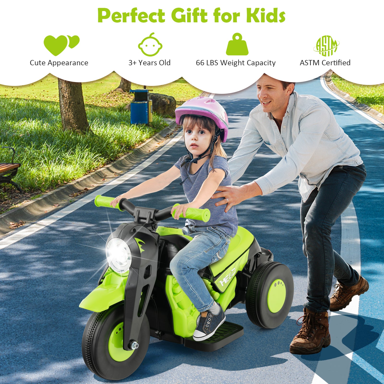 Child riding a green toy motorcycle with a adult pushing from behind on a sunny day.