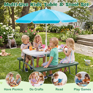 Children sitting at a kids table and stool set with a blue umbrella in a garden.