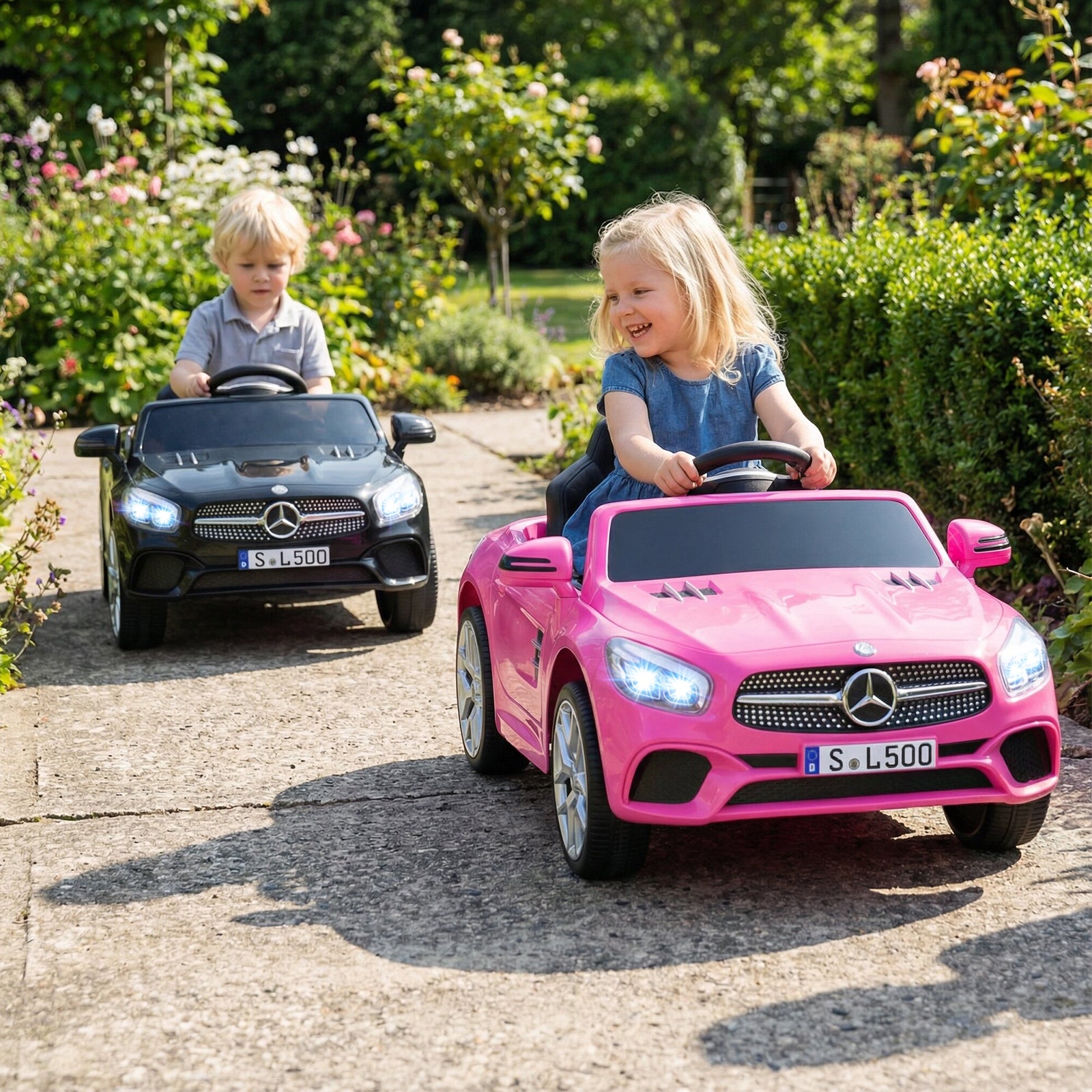 Two children playing with toy cars on a paved path in a garden.
