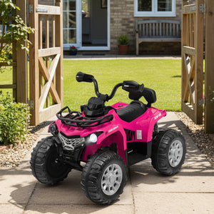Pink toy ATV on a patio with a garden and house in the background