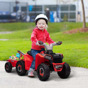 Child playing with a red toy ATV in an outdoor setting