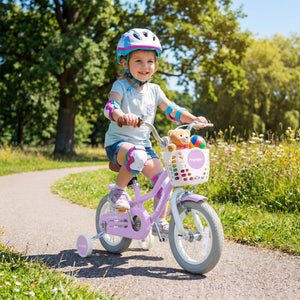 Child riding a pink bicycle with training wheels in a park