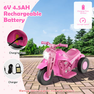 Pink toy motorcycle with charging port and battery information on a scenic background