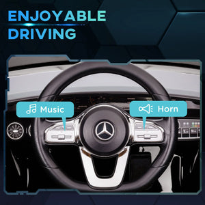 Happy child driving Mercedes AMG kids electric car.