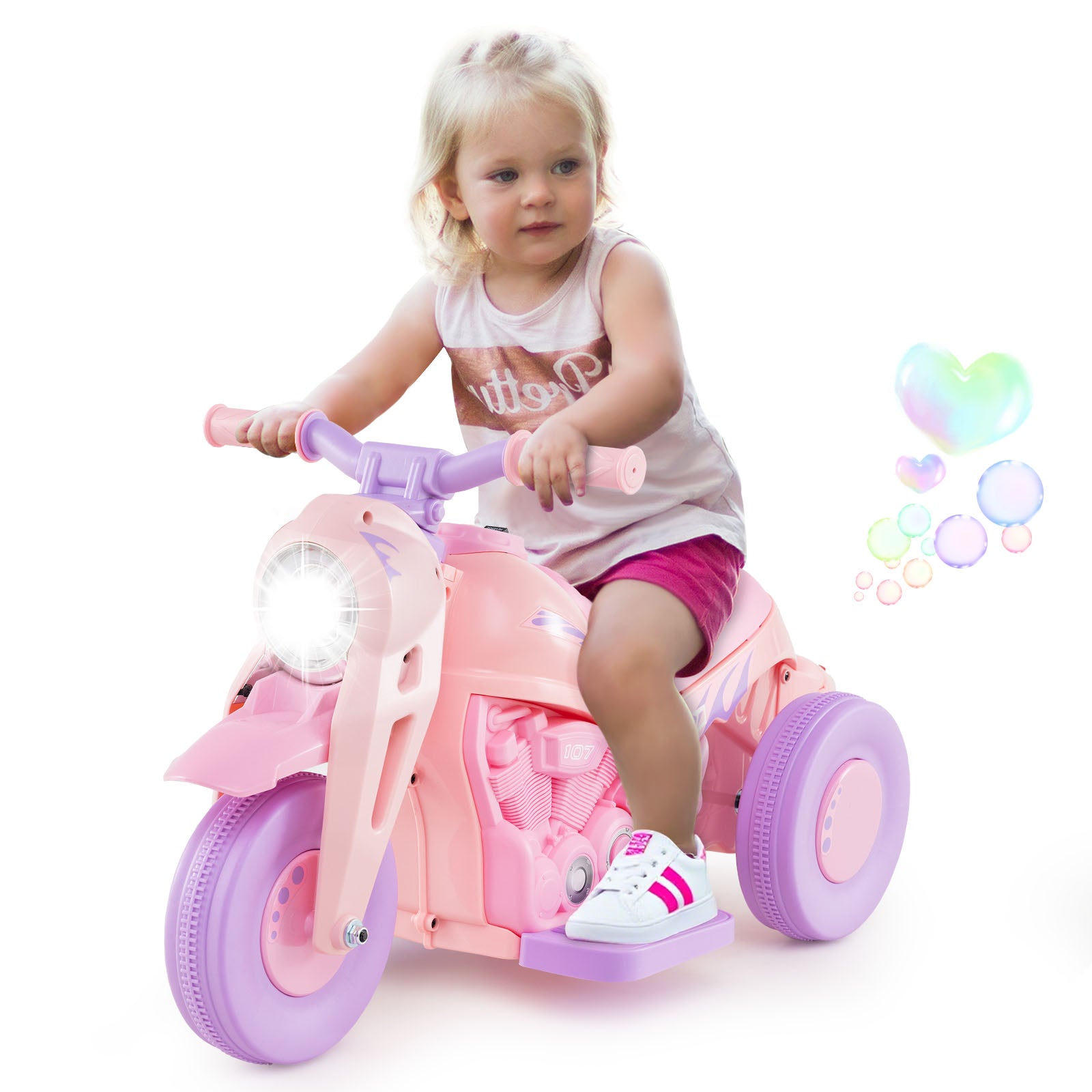 Child riding a pink and purple toy motorcycle with colorful bubbles in the background