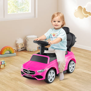 Child playing with a pink toy car in a room with toys and a window.