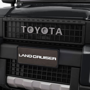 Close-up of Toyota Land Cruiser grille with brand logo.