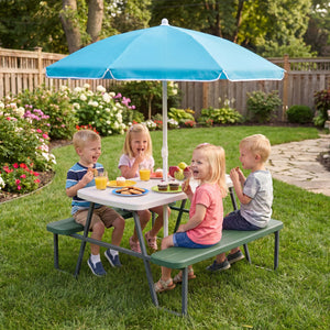 Children sitting at a picnic table with a blue umbrella in a garden setting